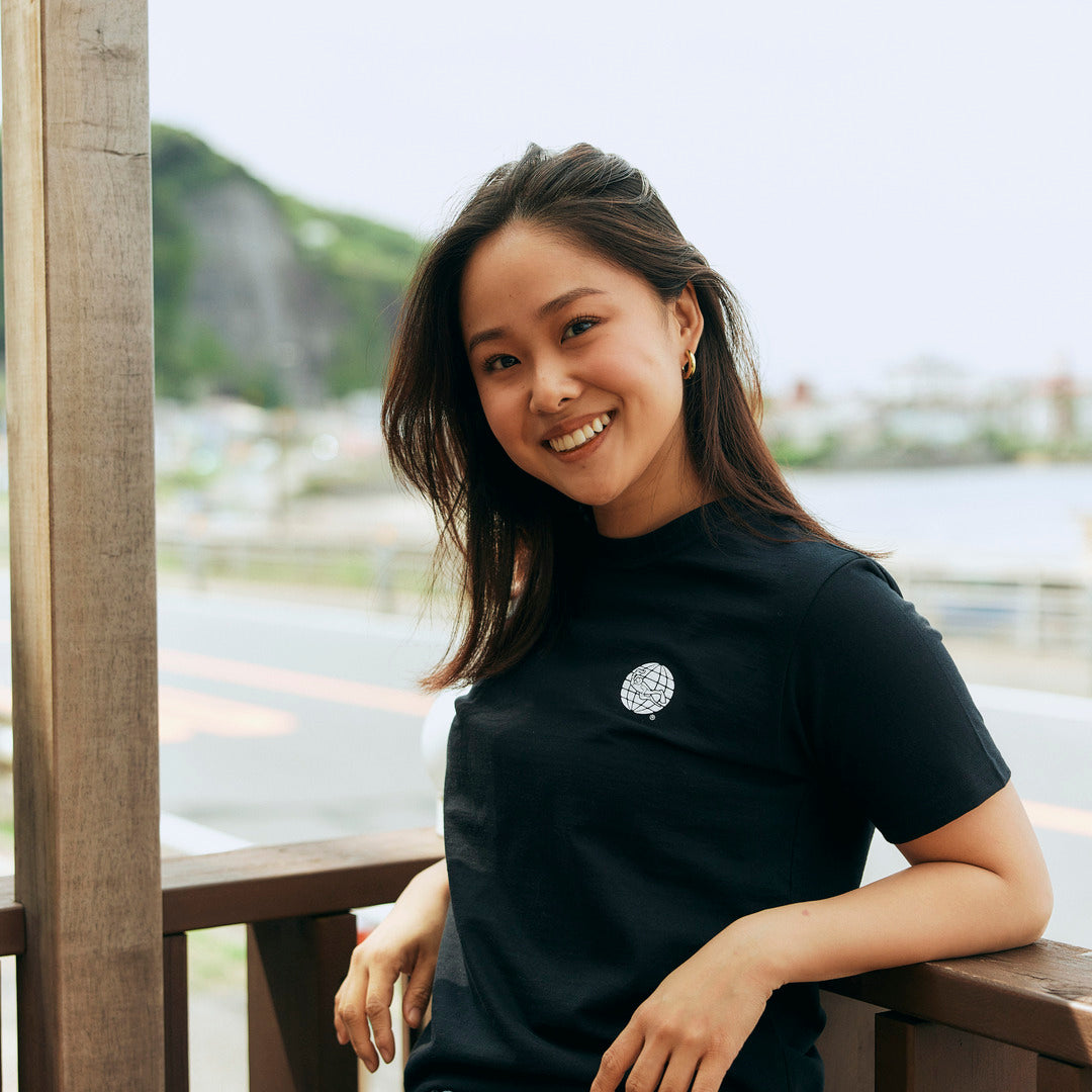 a model wearing a black t shirt with white PADI logo at the front.